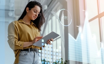 Professional analyzing digital data on a tablet, symbolizing the use of Voice AI and pattern recognition technology to enhance modern recruitment processes.